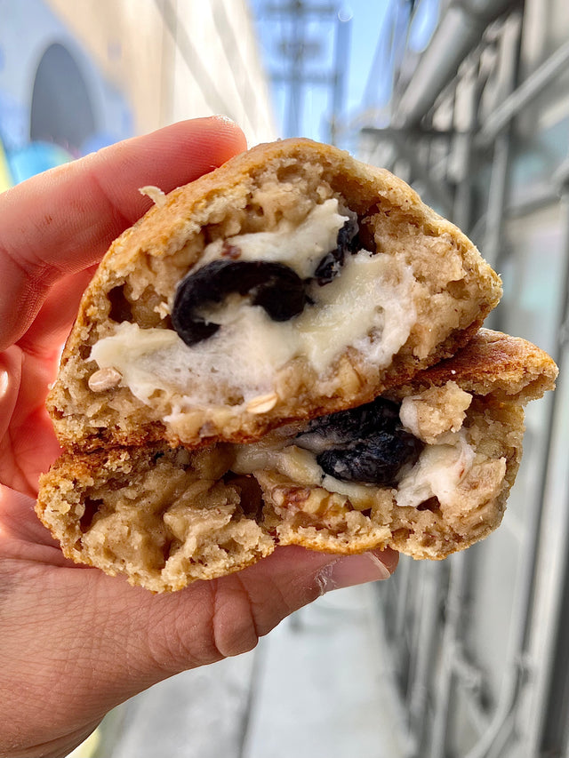 hand holding big fat greek stuffed gorumet cookie